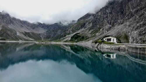 Scenic view of lake and mountains against sky