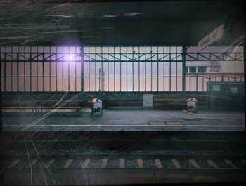 People walking on railroad station platform at night