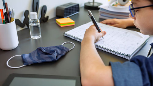 Midsection of person reading book on table