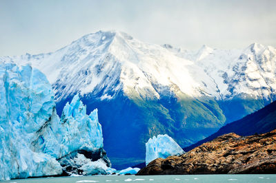 Scenic view of snow covered mountains against sky