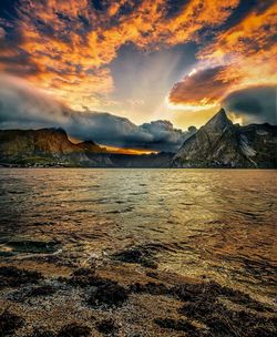 Scenic view of lake against dramatic sky