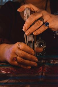 Midsection of woman holding playing cards