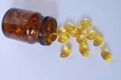 Close-up of yellow bottle against white background