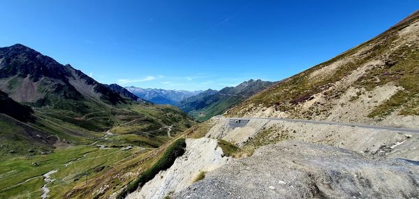 Scenic view of mountains against clear blue sky