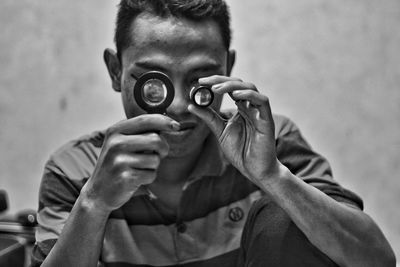 Man looking through magnifying glass