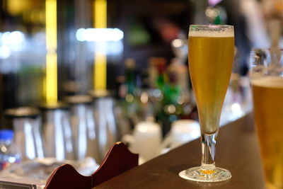 Close-up of beer glass on table