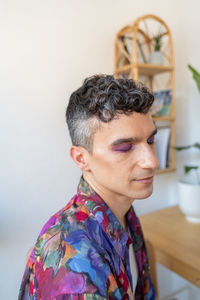 Closeup of fashionable young transgender man with glitters on eyeshadow