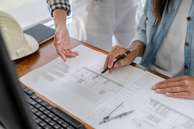 Low angle view of people working on table