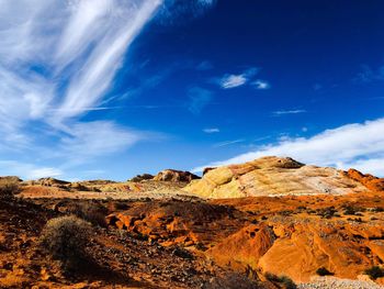 Scenic view of rock formations against blue sky