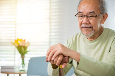 Senior man using mobile phone at home