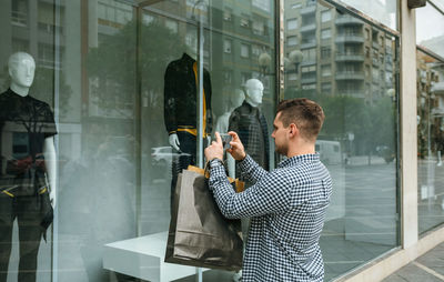 Reflection of man in glass window