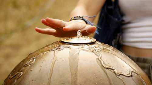 Close-up of woman touching a fountain