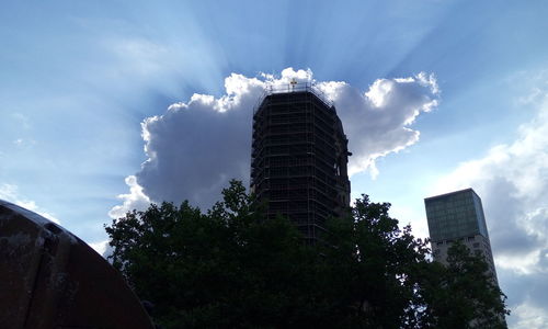 Low angle view of building against cloudy sky