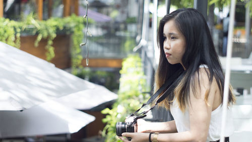 Portrait of young woman looking at camera