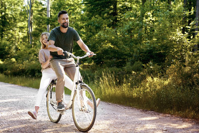 Side view of man riding bicycle on road