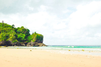 View of beach against cloudy sky