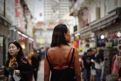 Women standing at store in city