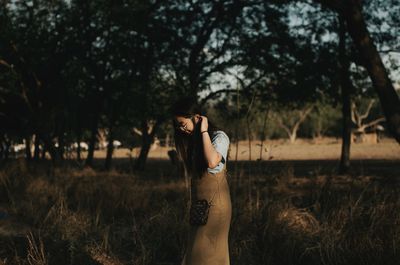 Side view of woman standing on field