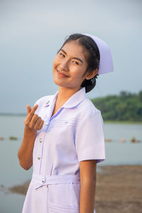 Smiling young nurse on field