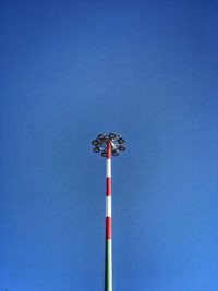 Low angle view of floodlight against blue sky