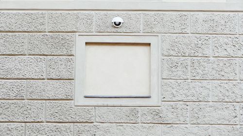 Security camera mounted on wall