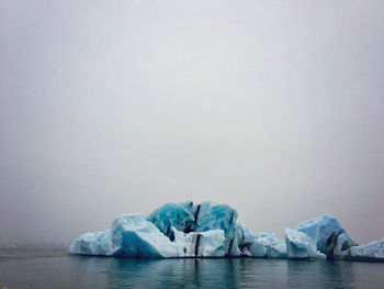 Scenic view of frozen lake against sky