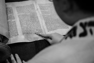 Midsection of woman reading book