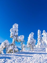 Scenic view of snow covered mountain against clear blue sky