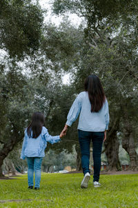 Rear view of women standing in park