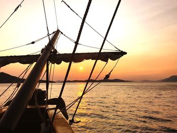 Silhouette boat on sea against sky during sunset