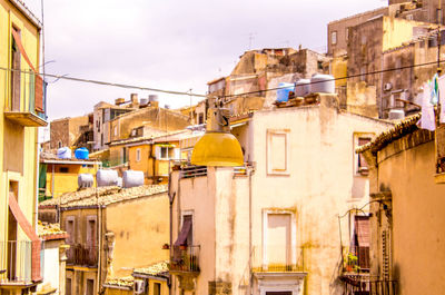 Low angle view of buildings in city against sky