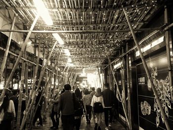 Group of people walking in illuminated building