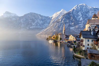 View of beautiful hallstatt lake and famous church during morning sunrise in early spring