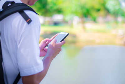 Midsection of man using mobile phone