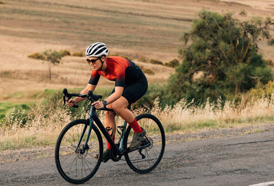 Man riding bicycle on field