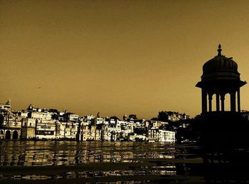 View of buildings in city at sunset