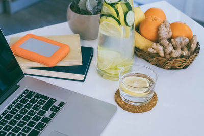 Morning time at home healthy breakfast laptop and drink on table. natural meal and fruits at work 