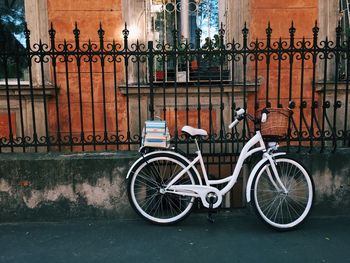 Bicycle parked against wall in city