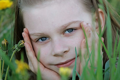 Close-up portrait of girl on field