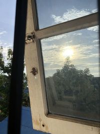 Low angle view of glass window against sky