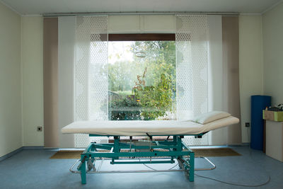 Empty chairs and table against window at home