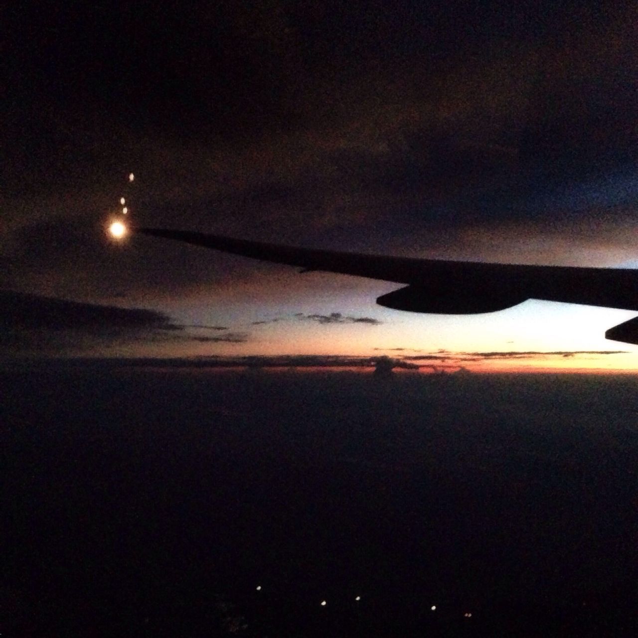 sea, sky, scenics, silhouette, night, illuminated, beauty in nature, tranquil scene, water, tranquility, sunset, transportation, flying, dusk, nature, dark, mode of transport, airplane, idyllic, horizon over water