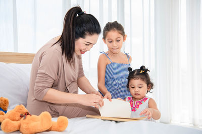 Mother and girl sitting at home