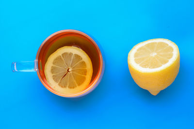 Close-up of drink on table against blue sky