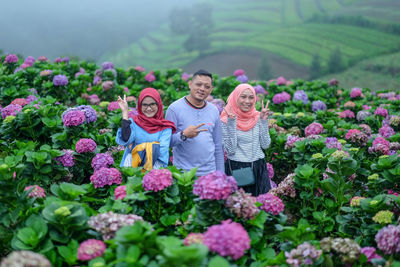 Rear view of people on flowering plants