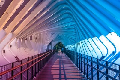 Rear view of man walking on footbridge