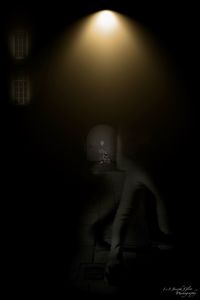 Man standing in illuminated dark room