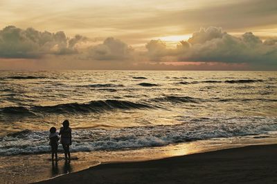 Silhouette of people on beach