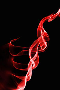 Close-up of illuminated lighting equipment against black background