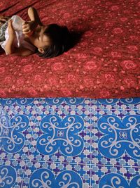 High angle view of woman relaxing on floor